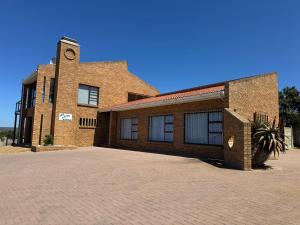 a brick building with a clock tower on top of it at Amia in Witsand