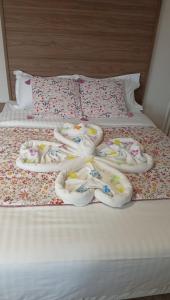 a bed with a bunch of towels on it at Le Faidherbe Hotel Coeur de ville in Boulogne-sur-Mer