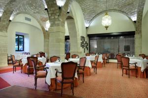 a large room with tables and chairs in it at Crisol Monasterio de San Miguel in El Puerto de Santa María