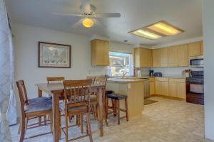 a kitchen with a table and chairs and a ceiling fan at Amber Sunset in Mosier