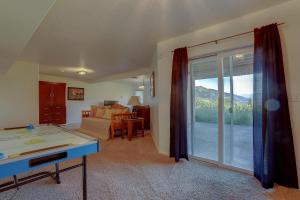 a living room with a pool table and a sliding glass door at Amber Sunset in Mosier
