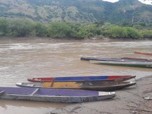 four boats sitting on the shore of a river at Casa Sol y Río in Honda