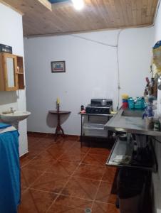 a kitchen with a counter and a sink in a room at Casa Sol y Río in Honda +3 photos