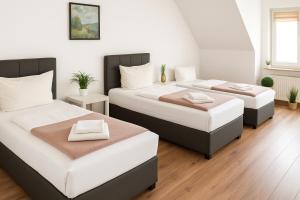 een kamer met drie bedden in een kamer bij SUNNYHOME Monteurwohnungen und Apartments nahe Regensburg in Nittendorf