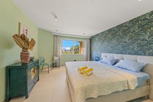 une chambre avec un grand lit et une télévision dans l'établissement The Strand apartment for 5 guests with pool and beach, à Willemstad 31 autres photos