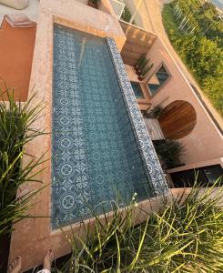 a swimming pool in the side of a house at Casa Kensho Sisal in Sisal