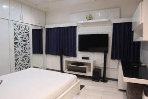 a bedroom with a bed and a flat screen tv at House of Raghuvansh in Jodhpur