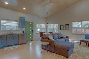 a living room with a couch and a kitchen at Mod Pod in Bend