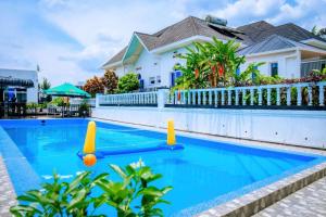 a swimming pool with two inflatable balls in a house at Zebra Domus in Huye