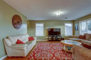 a living room with a couch and a tv at Northern Lights in White Salmon