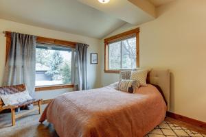 a bedroom with a large bed and a window at The Bend House in Bend