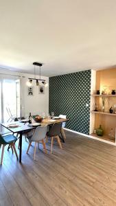 a dining room with a table and chairs in a room at La maison d a cote in Éguzon-Chantôme