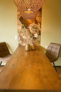 a dining room table with two chairs and a painting at Chalet Marter in Sellingen
