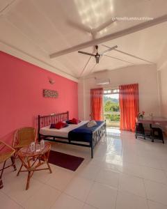 a bedroom with a bed and a table and chairs at New Blue Mount View Kandy in Kandy