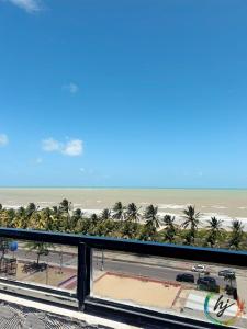 a view of the beach from the balcony of a resort at Ponta de Pedra 103 in Ilha da Restinga