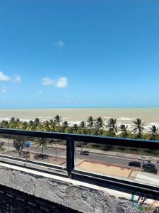a view of the beach from the balcony of a resort at Ponta de Pedra 103 in Ilha da Restinga