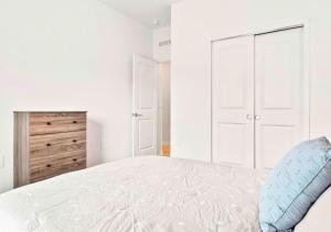 温特黑文Casa Inman - 3BR Luxury Stay Minutes from Legoland的白色卧室设有一张大床和一个梳妆台