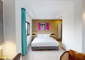 a bedroom with a bed and a painting on the wall at Aichti Hotel in Abidjan +13 photos