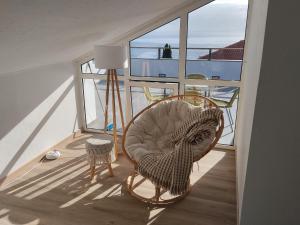a room with a chair and a lamp on a ship at Sky and Sea Haven in São Pedro