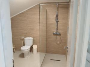 a bathroom with a toilet and a shower at Sky and Sea Haven in São Pedro
