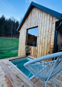 a pool with a bench in front of a building at Apartmány Motýlí louka in Albrechtice v Jizerských horách