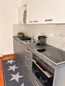 a kitchen with a sink and a counter top at Ascona: CÀ DAL DOLZ in Ascona