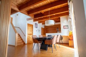 a dining room with wooden ceilings and a table and chairs at らくがきシーサイド牛窓 in Setouchi +39 photos