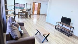 a living room with a couch and a table at Casa kuarahy in Asuncion