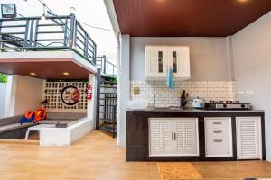 a kitchen with a sink and a staircase in a house at Ice Dragon Pool Villa ไอซ์ดราก้อน พูลวิลล่า in Ban Map Fakthong