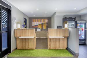 a restaurant with wooden counters and a green rug at Spark by Hilton Clarion in Clarion