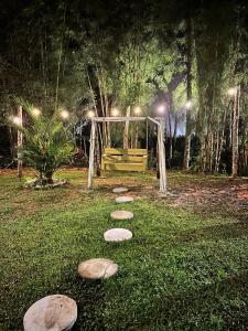 a set of stepping stones in a park at night at Cabaña con fogata BBQ y ríos cerro azul in Los Altos de Cerro Azul