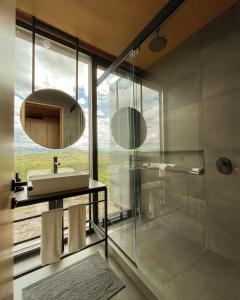 a bathroom with a sink and a shower with a window at Casa Mara Sierra 2 in Nueva Carrara +52 photos