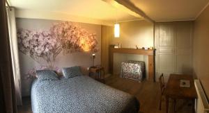 a bedroom with a bed and a flower mural on the wall at Chambres BB A Coste in Couloumé-Mondébat