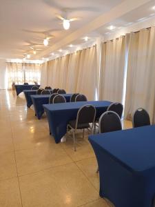 a row of blue tables and chairs in a room at Grande Hotel Amparo in Amparo +66 photos