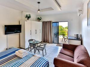 a living room with a couch and a table at Zur See - No Loadshedding in Ballito