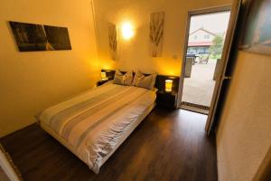 a bedroom with a bed and a sliding glass door at Apartment Chantal in Mostar
