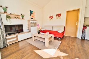 a living room with a red couch and a table at Apartment Chantal in Mostar