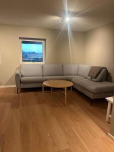 a living room with a couch and a table at Apartment right by Karmsund in Karmøy