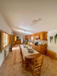 a large kitchen with a table and chairs in it at Finca roxana in Elda