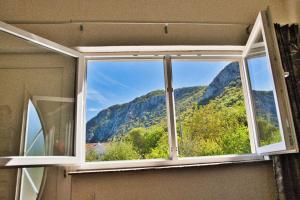 a window with a view of a mountain at Apartment Chantal in Mostar