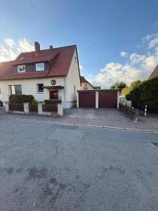 a house with a driveway and a garage at HarzRoots mit Garage in Bad Harzburg