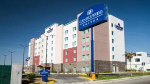 a large building with a sign in front of it at Candlewood Suites - Queretaro Juriquilla by IHG in Querétaro