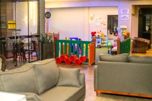 a living room with couches and a play area at Hotel Estrela do Mar in Penha