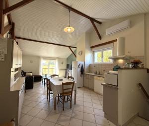 a kitchen and dining room with a table and chairs at Agueramonde in Mouguerre +20 photos