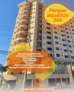 a tall building with a sign in front of it at Boulevard Suite in Caldas Novas