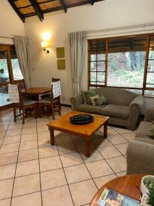 a living room with a couch and a table at Kruger Park Lodge Unit No. 543 in Hazyview