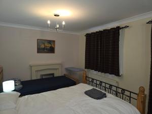 a bedroom with two beds and a fireplace at Colchester CO1 Hythe Ta in Hythe