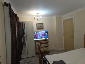 a bedroom with a bed and a flat screen tv at Colchester CO1 Hythe Ta in Hythe