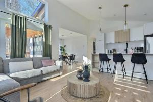 a living room with a couch and a table at Chalet Arianna in Pont-Rouge