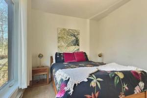 a bedroom with a bed and a window at Chalet Arianna in Pont-Rouge +23 photos